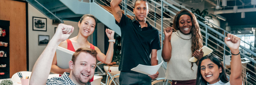 An happy team in the hall of the office